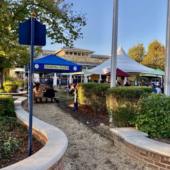 Coastal Flats - a view of a park with tables and umbrellas - Seafood Near Me - Fairfax, Virginia Coastal Flats - a view of a park with tables and umbrellas - Seafood Near Me - Fairfax, Virginia