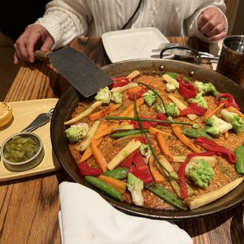 Coqueta - The pièce de résistance! Paella! With a side of lemon and peppers. - Spanish Near Me - San Francisco, California Coqueta - The pièce de résistance! Paella! With a side of lemon and peppers. - Spanish Near Me - San Francisco, California