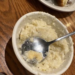 The kitchen is using the same serving utensils to spoon out sides. The kitchen is using the same serving utensils to spoon out sides.