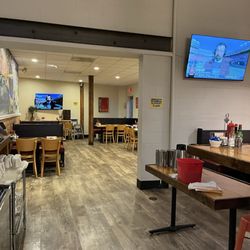 ACME Cafe - The tvs and seating in this small and quaint space. We sit at the bar!