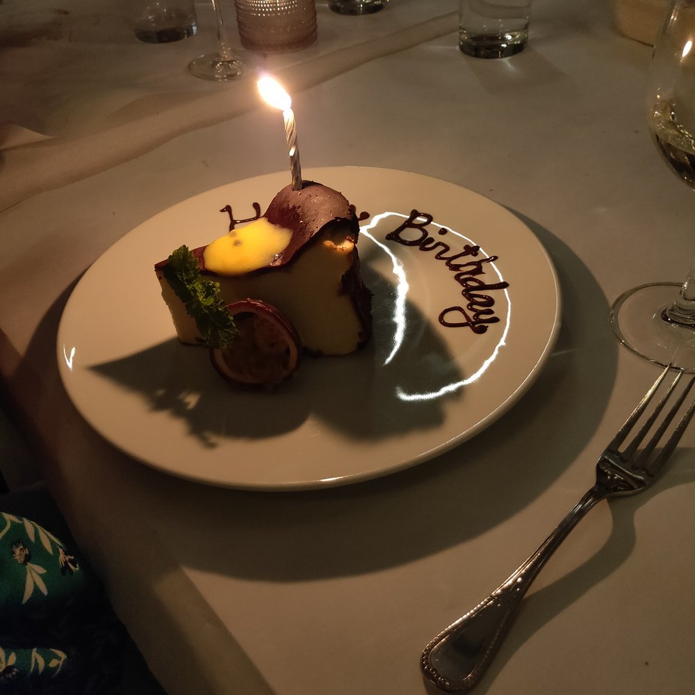 Leña Restaurante - Burnt cheesecake with "Happy birthday" written on it - Latin American Near Me - Toronto, Ontario Leña Restaurante - Burnt cheesecake with "Happy birthday" written on it - Latin American Near Me - Toronto, Ontario