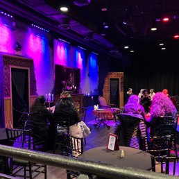 a stage with people sitting at tables
