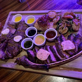 STK Steakhouse - The Board: Tomahawk, Seabass, Porterhouse, Shrimp. And plenty of sauces. (Sides not pictured) - Venues & Event Spaces Near Me - Dallas, Texas
