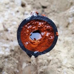 Hard water build up in a pipe from an older home.