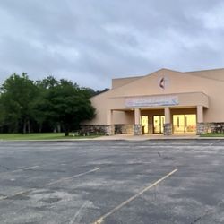 Glen Lake Camp & Retreat Center - The basketball gym (no exercise equipment) with four square, several basketball hoops, & stadium seats.