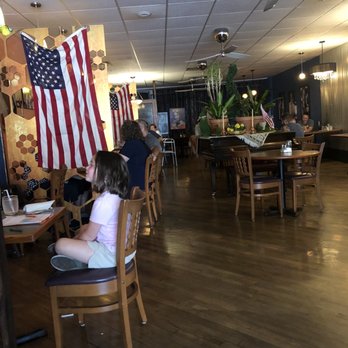 Sweet Tooth Cafe - a little girl sitting at a table with an american flag hanging from the ceiling - Ice Cream & Frozen Yogurt Near Me - Shamokin, Pennsylvania Sweet Tooth Cafe - a little girl sitting at a table with an american flag hanging from the ceiling - Ice Cream & Frozen Yogurt Near Me - Shamokin, Pennsylvania