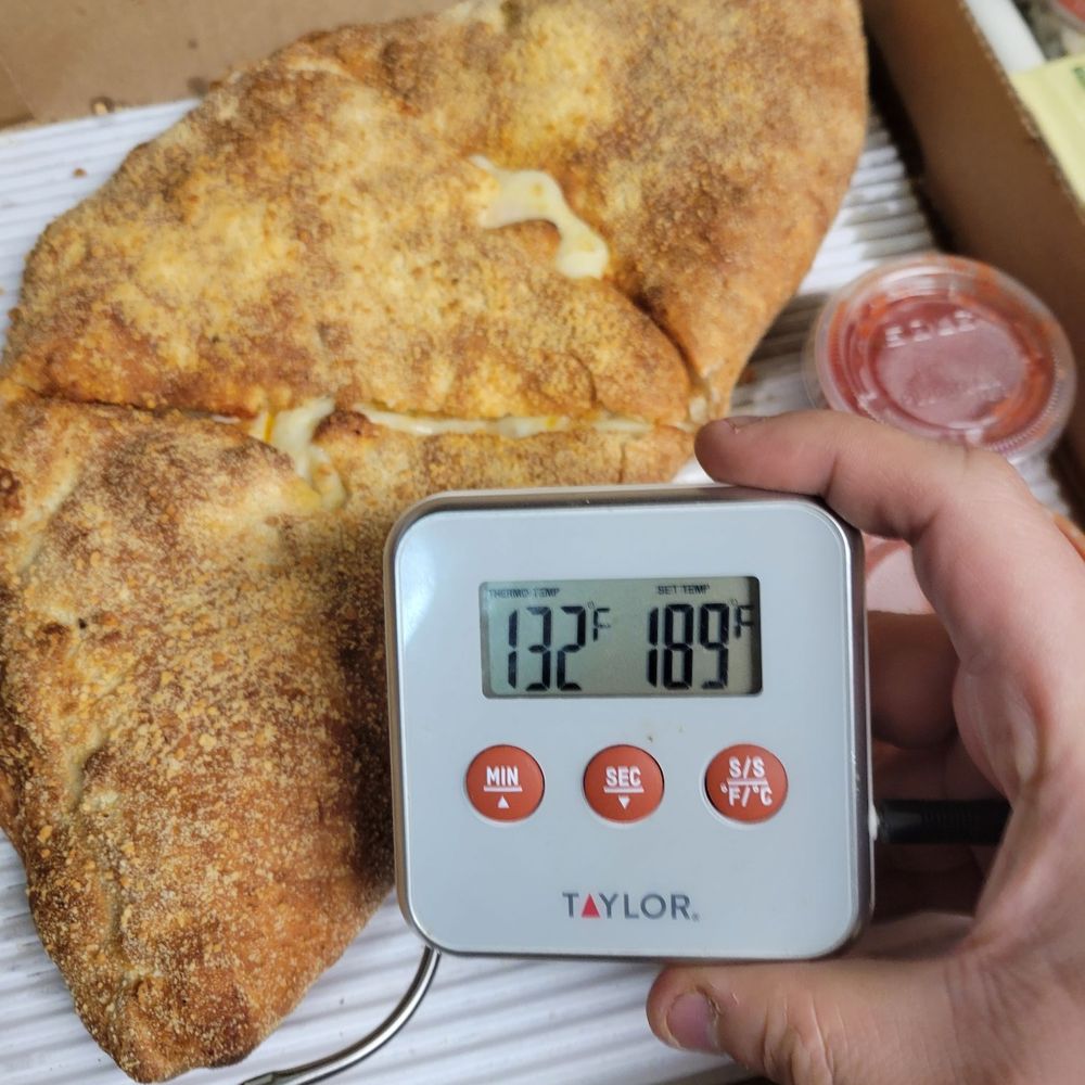 A delivered calzone. When separated there was no cheese stretch. I had to reheat this immediately upon receiving it. A delivered calzone. When separated there was no cheese stretch. I had to reheat this immediately upon receiving it.