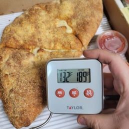 A delivered calzone. When separated there was no cheese stretch. I had to reheat this immediately upon receiving it. A delivered calzone. When separated there was no cheese stretch. I had to reheat this immediately upon receiving it.