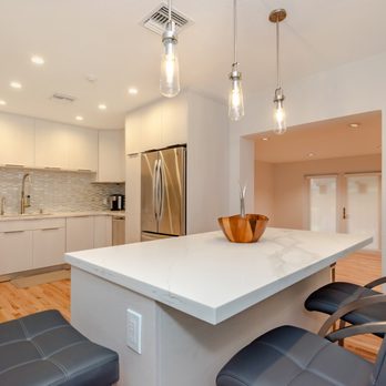 Unique Construction - Custom, all-white kitchen remodel with recessed & pendant lights to give this kitchen a warm feel! - General Contractors Near Me - Miami, Florida