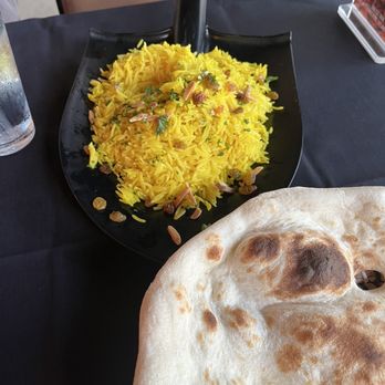 Kahramana Restaurant - Rice on a shovel and partial pic of the flatbread that was the size of pizza! - Middle Eastern Near Me - Upland, California Kahramana Restaurant - Rice on a shovel and partial pic of the flatbread that was the size of pizza! - Middle Eastern Near Me - Upland, California