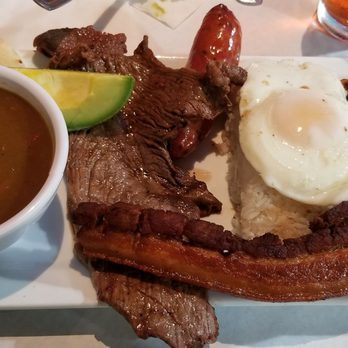 Bandeja Paisa - Bandeja Paisa. UNBELIEVABLE  if you're starving. Its HUGE!!.  RICE, BEANS, STEAK, PORK, SAUSAGE,  AVOCADO topped off with a fried egg. - Colombian Near Me - Orlando, Florida