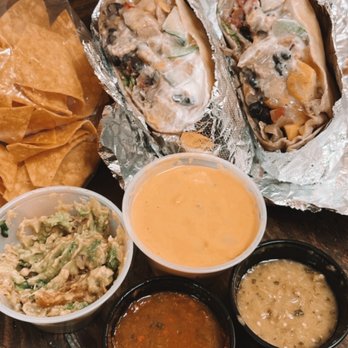 The Well Dressed Burrito - Grilled Burrito (right), queso / guac / hot sauce / chips (left) - Mexican Near Me - Washington, DC, District of Columbia The Well Dressed Burrito - Grilled Burrito (right), queso / guac / hot sauce / chips (left) - Mexican Near Me - Washington, DC, District of Columbia