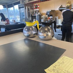 Waffle House - Chocolate milk sitting next to the refrigerator for an hour or more. Why are there empty coffee pots on the bar?