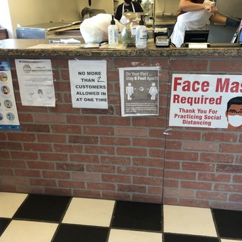Janos Pizza - a brick counter with a sign that says face mask required - Pizza Near Me - Alpine, California
