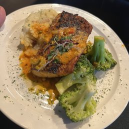 Salmon with mashed potatoes and broccoli.
