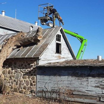 Tischer's Tree & Landscape - a man on a cherry picker - Landscaping Near Me - Sullivan, Wisconsin Tischer's Tree & Landscape - a man on a cherry picker - Landscaping Near Me - Sullivan, Wisconsin