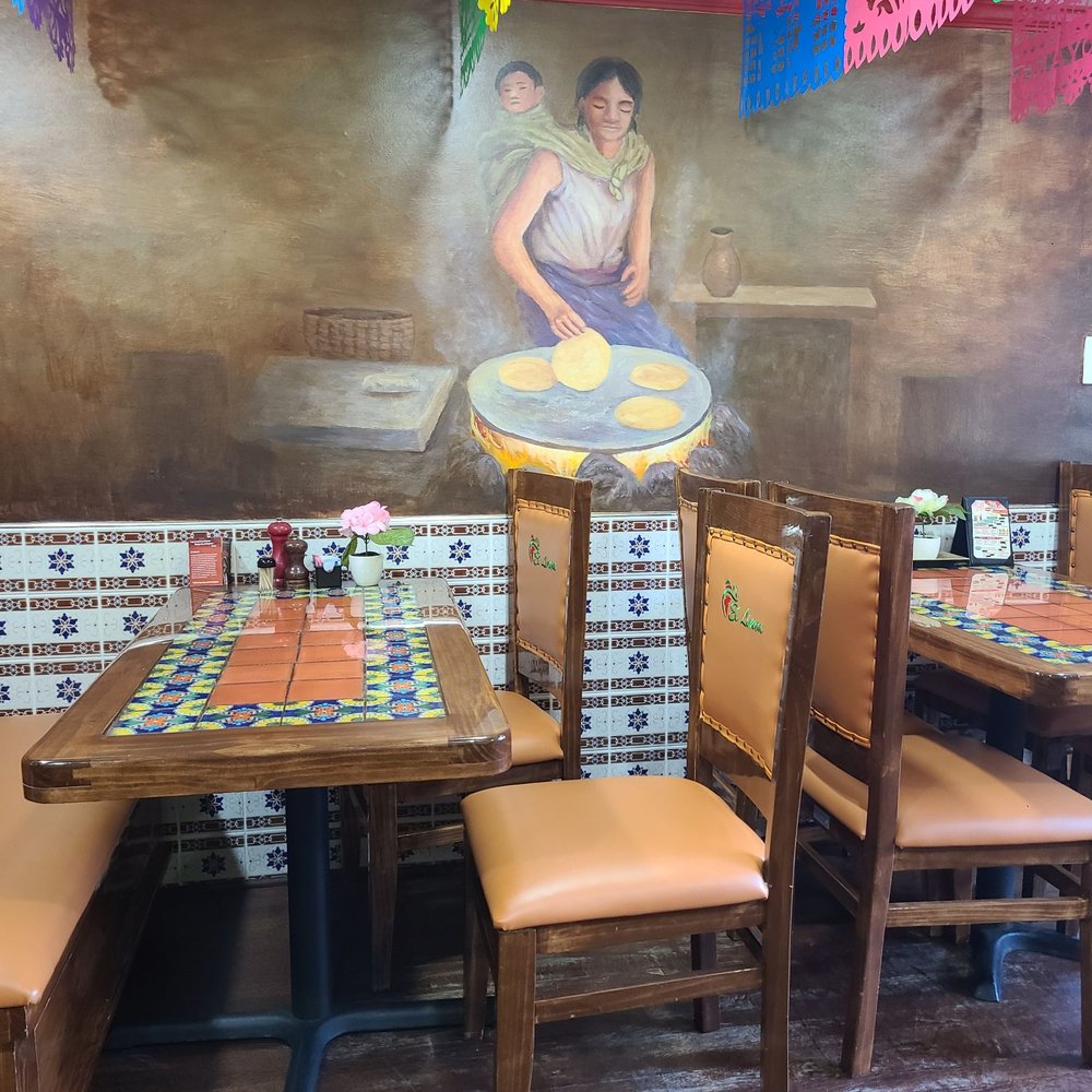 Inside seating wall with a picture of a Mexican woman making tortillas with her baby on her back Inside seating wall with a picture of a Mexican woman making tortillas with her baby on her back
