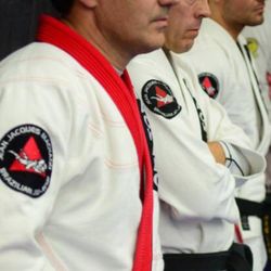 Jean Jacques Machado Brazilian Jiu-Jitsu Academy - Jean Jacques Machado watching on with a few of his black belts standing next to him.