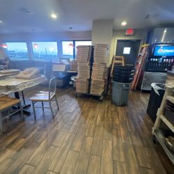 Pizza Hut - This is inside the restaurant.  A ladder, stacks of boxes, stacks of trash cans. Just crazy.