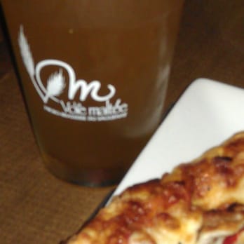 La Voie Maltée - Blonde with pizza - Pubs Near Me - Chicoutimi, Quebec