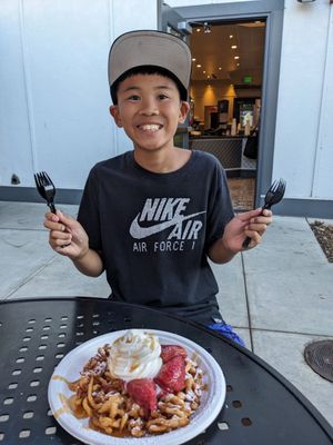 Photo of California's Great America - Santa Clara, CA, US. Boy wanted the funnel cake before leaving the park.