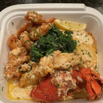 Dee Queezys - Lobster and shrimp over fried cheese grits with sautés spinach. - Food Trucks Near Me