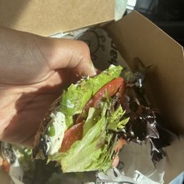 Well toasted Sesame bagel with avocado lettuce tomatoes salt and pepper Well toasted Sesame bagel with avocado lettuce tomatoes salt and pepper