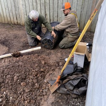 Cravinho Landscape & Lighting - two men working on the ground - Landscaping Near Me Cravinho Landscape & Lighting - two men working on the ground - Landscaping Near Me