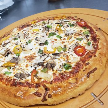 Ringers Original Pizza - a pizza on a wooden board - Pizza Near Me - Saskatoon, Saskatchewan Ringers Original Pizza - a pizza on a wooden board - Pizza Near Me - Saskatoon, Saskatchewan