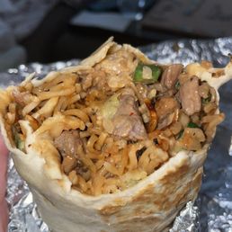a hand holding a burrito a hand holding a burrito