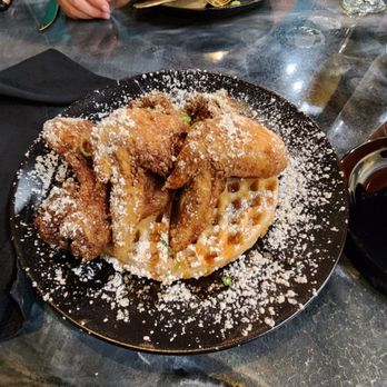 Cameals Cuisine - Chicken & Waffles with breakfast burrito in the background - Caribbean Near Me - Loganville, Georgia