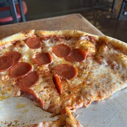 The delicious leftovers from a half pepperoni half cheese pizza