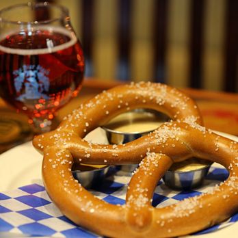 Sundog Visuals - A soft, warm pretzel perfection paired with creamy cheese sauce, tangy mustard, and a glass of red wine at The Bier Stein. Sundog Visuals. - Video/Film Production Near Me