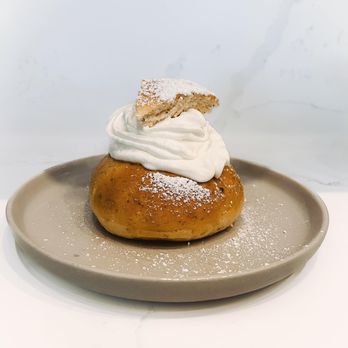 Sunrisen Bakery - a doughnut with whipped cream on top - Desserts Near Me Sunrisen Bakery - a doughnut with whipped cream on top - Desserts Near Me