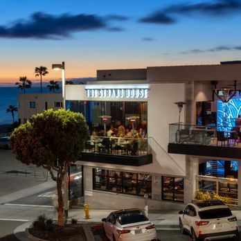 StrandBar - cars parked in front of the restaurant - Cocktail Bars Near Me - Manhattan Beach, California