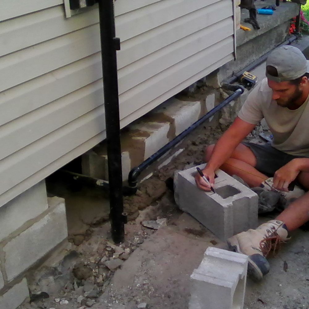 Burriss Masonry - Brad is measuring and drawing on a block before cutting it. - Masonry/Concrete Near Me - Kingston, Ontario Burriss Masonry - Brad is measuring and drawing on a block before cutting it. - Masonry/Concrete Near Me - Kingston, Ontario