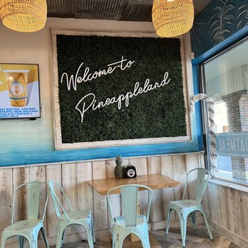 Playa Bowls - a table and chairs in front of a chalk board - Juice Bars & Smoothies Near Me - Wilmington, Delaware