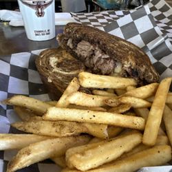 The Camphouse - Brisket melts on marble rye side of homemade french fries