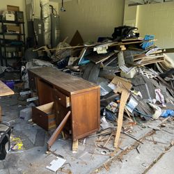 Garage full of furniture and construction debris
