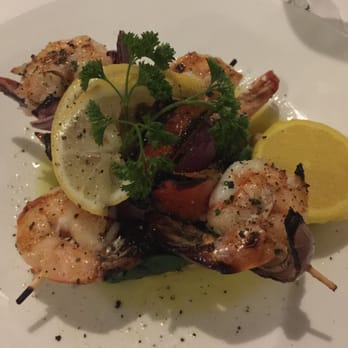 Mediterraneo - Skewered shrimp over sautéed spinach and chick peas - Pizza Near Me - Sarasota, Florida Mediterraneo - Skewered shrimp over sautéed spinach and chick peas - Pizza Near Me - Sarasota, Florida