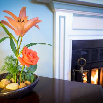 Briar Rose Bed and Breakfast - Flower arrangement near the cozy fireplace in our largest room, the Blanca Room. - Bed & Breakfast Near Me - Boulder, Colorado Briar Rose Bed and Breakfast - Flower arrangement near the cozy fireplace in our largest room, the Blanca Room. - Bed & Breakfast Near Me - Boulder, Colorado