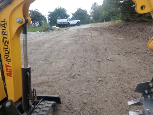 driveway grading - customer had driveway sloping toward house causing flooding. brought grade slope down 10" away from house to fix. driveway grading - customer had driveway sloping toward house causing flooding. brought grade slope down 10" away from house to fix.