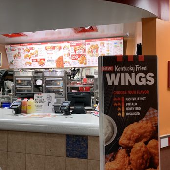 KFC - a man ordering food at a fast food restaurant - Chicken Wings Near Me - Iselin, New Jersey