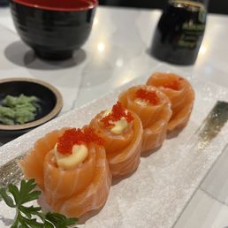 four pieces of sushi on a white plate four pieces of sushi on a white plate