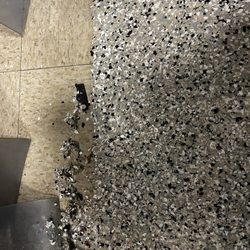 Concrete Flooring Solutions of Ohio - Messy application of epoxy flake floor under doorways.