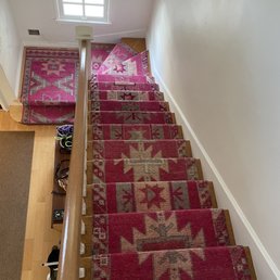 a staircase with a carpet runner a staircase with a carpet runner