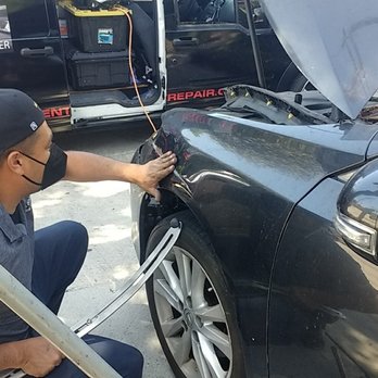 Premier Paintless Dent Repair - Raul begins to work the metal with great skill and care to undo the deep scrape and dent. - Mobile Dent Repair Near Me - South Bend, Indiana Premier Paintless Dent Repair - Raul begins to work the metal with great skill and care to undo the deep scrape and dent. - Mobile Dent Repair Near Me - South Bend, Indiana