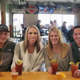 a group of people sitting at a bar a group of people sitting at a bar
