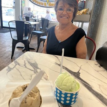 Hershey's Of Ormond Beach - Mary sampling some pistachio flavor ice cream at Hershey's of Ormond Beach, and my brown butter bourbon in the front cup - Ice Cream & Frozen Yogurt Near Me - Ormond Beach, Florida