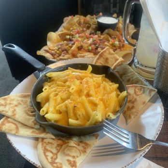 Hops n Drops - Mac and cheese with homemade potato chips with cheese and topping in background. - Salad Near Me - Auburn, Washington Hops n Drops - Mac and cheese with homemade potato chips with cheese and topping in background. - Salad Near Me - Auburn, Washington